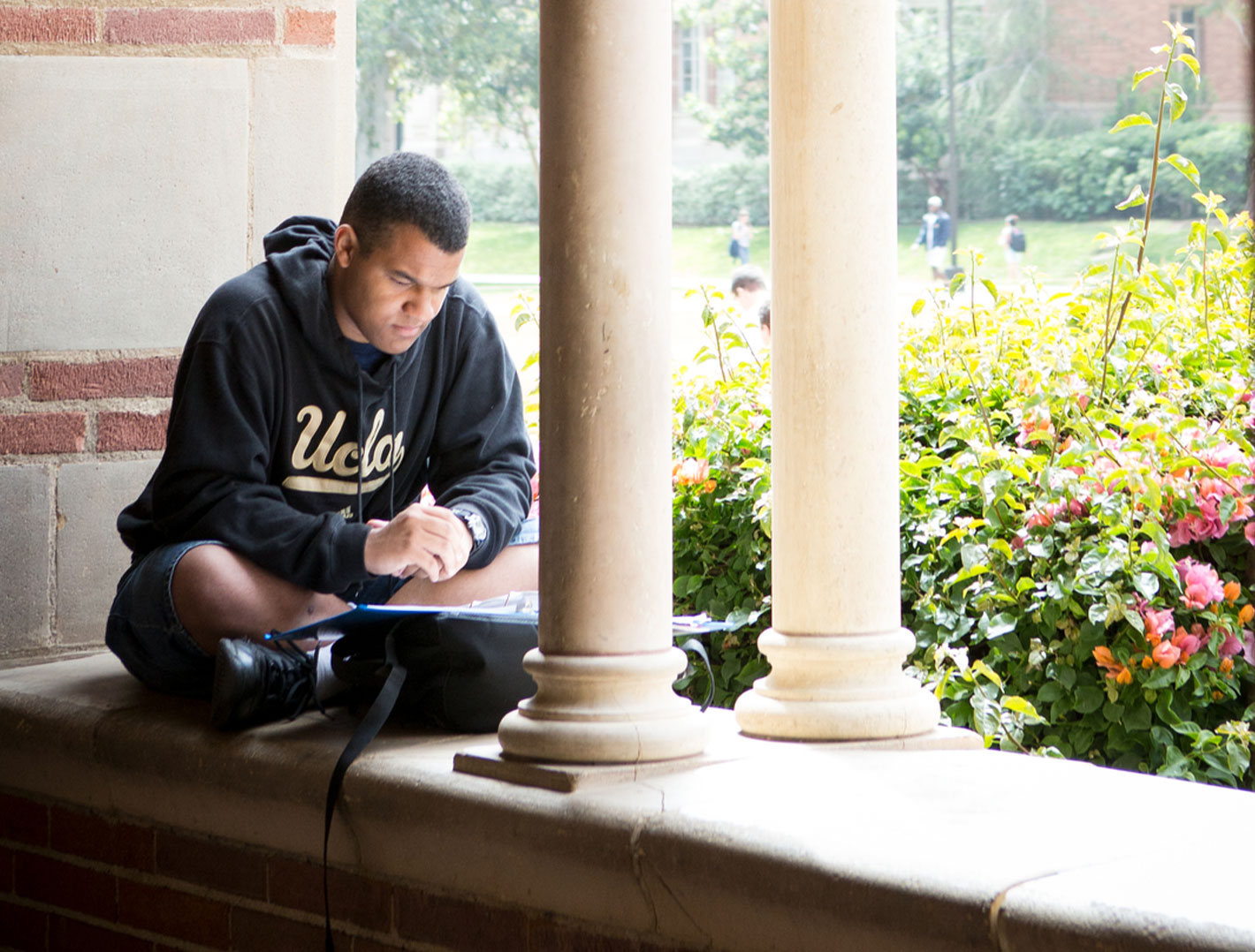 student reading on campus